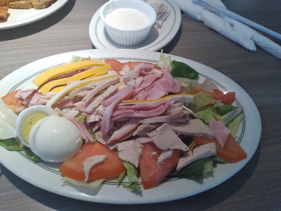 Printed menu with salads, plates, and coffee.